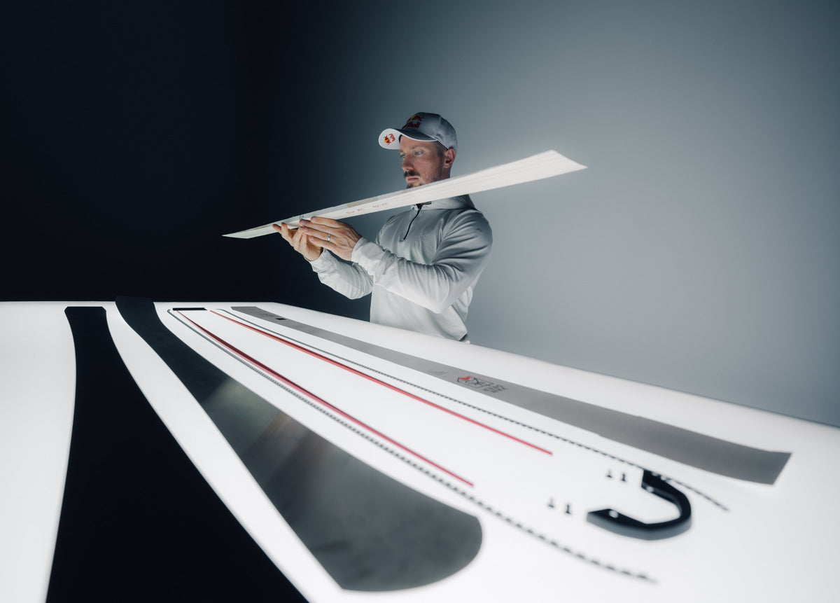 Marcel Hirscher checks a ski layer over the light table with the components of a VAN DEER ski